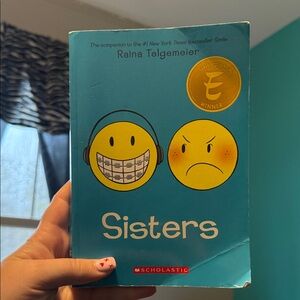Scholastic 'Sisters' Graphic Novel with Blue Cover